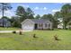 Charming home featuring a well-manicured lawn, attached garage, and inviting curb appeal at 30 Cornerstone Dr, Franklinton, NC 27525