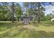 View of a single story shed on a grass lot and accented by mature trees at 30 Cornerstone Dr, Franklinton, NC 27525