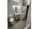 Bathroom with grey cabinets, modern fixtures, and washer/dryer combination unit at 3047 Huntleigh Dr, Raleigh, NC 27604