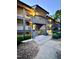 Condominium building with multiple stories, walkways, and stairs, surrounded by trees and landscaping at 3047 Huntleigh Dr, Raleigh, NC 27604