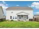 The backyard view highlights the home's screened in porch and sprawling grassy lawn at 316 Wellwater Ave, Durham, NC 27703