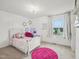 Bright, charming bedroom with themed decor, a window view, and a playful chandelier at 316 Wellwater Ave, Durham, NC 27703