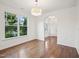 Bright dining room features gleaming hardwood floors, large window, and modern lighting fixture at 316 Wellwater Ave, Durham, NC 27703