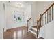 Bright foyer with hardwood floors, staircase, and a clear view through the glass front door at 316 Wellwater Ave, Durham, NC 27703