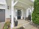 Inviting front porch with rocking chairs, decorative plants, and stylish exterior details on a well-maintained home at 316 Wellwater Ave, Durham, NC 27703