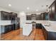 Modern kitchen with stainless steel appliances, white countertops, and dark cabinetry, and a white kitchen island at 316 Wellwater Ave, Durham, NC 27703