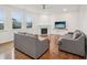 Cozy living room with hardwood floors, fireplace, ceiling fan, and comfortable seating at 316 Wellwater Ave, Durham, NC 27703