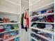 Organized walk-in closet with white shelving and visible storage boxes, for optimal storage solutions at 316 Wellwater Ave, Durham, NC 27703