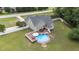 Aerial view of the backyard with a pool, hot tub, deck and screened in porch at 3216 Nc Hwy 42, Willow Springs, NC 27592