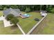 Expansive fenced backyard with pool, deck, shed, shelter, and trampoline perfect for outdoor activities at 3216 Nc Hwy 42, Willow Springs, NC 27592
