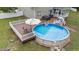 Aerial view of backyard with pool, hot tub, deck, and lounge furniture at 3216 Nc Hwy 42, Willow Springs, NC 27592