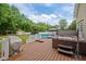 Fenced backyard features a deck, pool, hot tub and storage shed at 3216 Nc Hwy 42, Willow Springs, NC 27592