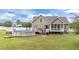 Inviting backyard with a pool, deck, and a well-maintained lawn ideal for relaxation and entertainment at 3216 Nc Hwy 42, Willow Springs, NC 27592