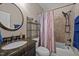 Cozy bathroom features a dark vanity and shower and bath with patterned curtain at 3216 Nc Hwy 42, Willow Springs, NC 27592