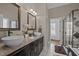 Bathroom featuring dual sinks, granite countertops, and a separate shower area with patterned tiles at 3216 Nc Hwy 42, Willow Springs, NC 27592