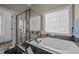 Luxury bathroom with a soaking tub, shower, and decorative stained glass window for added privacy at 3216 Nc Hwy 42, Willow Springs, NC 27592