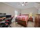 Bright bedroom with wood-look floors, natural light, and gaming setup at 3216 Nc Hwy 42, Willow Springs, NC 27592