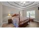 Cozy bedroom features a decorative bed, tray ceiling, and soft lighting from bedside lamps at 3216 Nc Hwy 42, Willow Springs, NC 27592