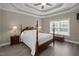 Serene bedroom with a four-poster bed, tray ceiling, and soft lighting, creating a relaxing atmosphere at 3216 Nc Hwy 42, Willow Springs, NC 27592