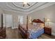 Bedroom with decorative bed, tray ceiling, bedside lamps, and direct access to additional rooms at 3216 Nc Hwy 42, Willow Springs, NC 27592