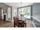 Sunlit dining room features a wooden table, chandelier, and a large window overlooking the outdoor space at 3216 Nc Hwy 42, Willow Springs, NC 27592
