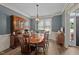 Dining room with wooden furniture, a chandelier, and a china cabinet against a blue accent wall at 3216 Nc Hwy 42, Willow Springs, NC 27592