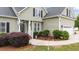 Beautiful entrance with an inviting doorway, front yard landscaping, and manicured shrubbery at 3216 Nc Hwy 42, Willow Springs, NC 27592