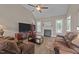 Spacious living room featuring a fireplace, hardwood floors, large TV, and a vaulted ceiling at 3216 Nc Hwy 42, Willow Springs, NC 27592