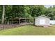 Backyard shed and shelter perfect for storage and outdoor equipment, enhancing functionality of the property at 3216 Nc Hwy 42, Willow Springs, NC 27592