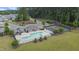 Aerial view of a community pool, tennis courts and surrounding landscaping at 3309 Turner Ridge Dr, New Hill, NC 27562