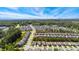Aerial view of a suburban neighborhood surrounded by green areas and a water tower in distance at 3309 Turner Ridge Dr, New Hill, NC 27562