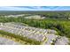 Aerial view of a beautiful residential community with many homes surrounding a pond with lush green landscape at 3309 Turner Ridge Dr, New Hill, NC 27562