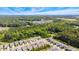 Expansive aerial view of a suburban community nestled amongst lush green trees under a bright blue partly cloudy sky at 3309 Turner Ridge Dr, New Hill, NC 27562
