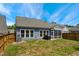 Fenced backyard with some grass, patio and screened in porch at 3309 Turner Ridge Dr, New Hill, NC 27562