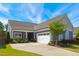 Charming home featuring blue siding, a two-car garage, manicured landscaping, and a well-maintained front yard at 3309 Turner Ridge Dr, New Hill, NC 27562