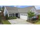 Lovely blue home with a two-car garage, complemented by lush landscaping and a well-kept lawn at 3309 Turner Ridge Dr, New Hill, NC 27562
