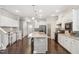 Well-designed kitchen featuring granite countertops, white cabinets, and a large island, open to the living space at 3309 Turner Ridge Dr, New Hill, NC 27562