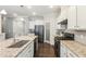 Bright kitchen with granite countertops, stainless steel appliances, and dark hardwood flooring at 3309 Turner Ridge Dr, New Hill, NC 27562