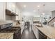 Stylish kitchen featuring granite countertops, stainless steel appliances and a spacious island with seating at 3309 Turner Ridge Dr, New Hill, NC 27562