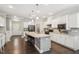 Modern kitchen with white cabinetry, granite countertops, a large island, and stainless steel appliances at 3309 Turner Ridge Dr, New Hill, NC 27562