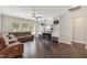 Cozy living room featuring a large sectional sofa, built-in shelving, and a ceiling fan at 3309 Turner Ridge Dr, New Hill, NC 27562