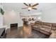 Living room with hardwood floors, modern furnishings, and an open view to the kitchen at 3309 Turner Ridge Dr, New Hill, NC 27562