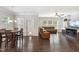 Open-concept living and dining area with hardwood floors and a comfortable sectional couch at 3309 Turner Ridge Dr, New Hill, NC 27562