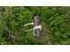 Stunning aerial view of two homes nestled among lush, mature trees and professionally landscaped yards at 3323 Cheswick Dr, Raleigh, NC 27609