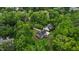 Aerial view of home surrounded by lush greenery, a private driveway, and a well-maintained landscape at 3323 Cheswick Dr, Raleigh, NC 27609