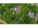 An aerial view shows homes surrounded by mature trees and landscaping creating a private, wooded setting at 3323 Cheswick Dr, Raleigh, NC 27609