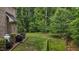 A view of the lush backyard, mature trees, and creek at 3323 Cheswick Dr, Raleigh, NC 27609