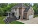 View of the home's rear featuring a spacious deck, screened-in porch, and brick accents at 3323 Cheswick Dr, Raleigh, NC 27609