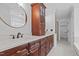 Bright bathroom with dual sinks, granite counters, and dark wood cabinets at 3323 Cheswick Dr, Raleigh, NC 27609