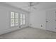 Bright bedroom with a ceiling fan, carpet, and large windows with custom blinds at 3323 Cheswick Dr, Raleigh, NC 27609